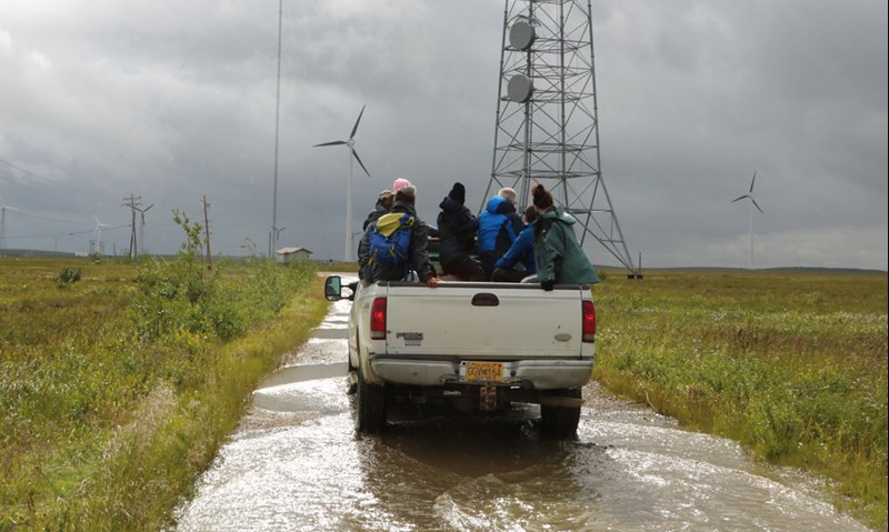 Participants arrive at Kotzebue Electric Association's wind and solar farm.